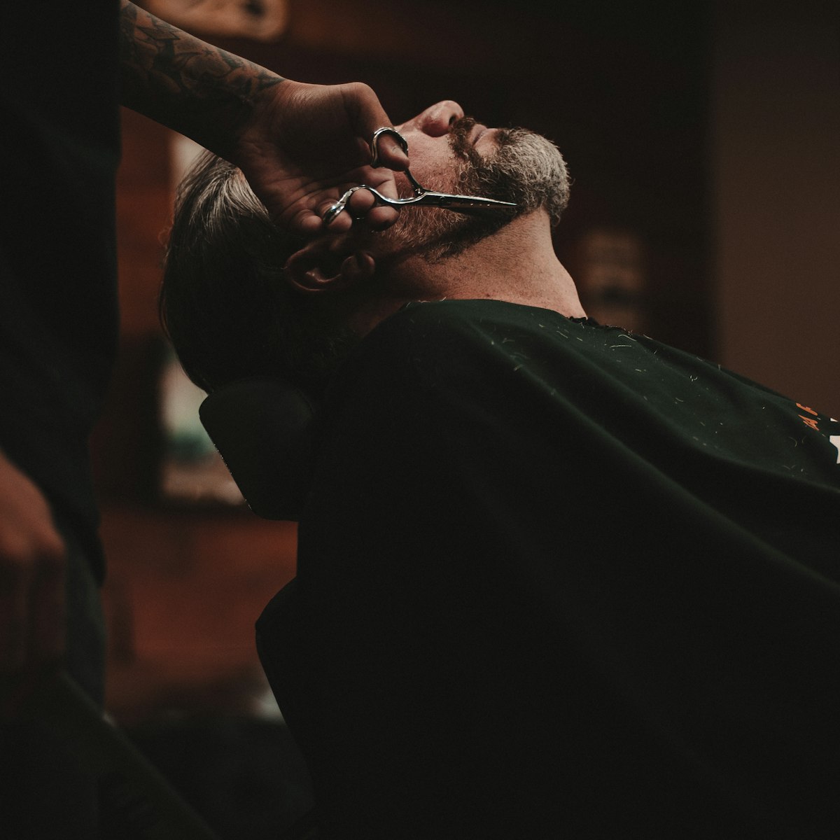 Client leaned back for a scissor beard trim