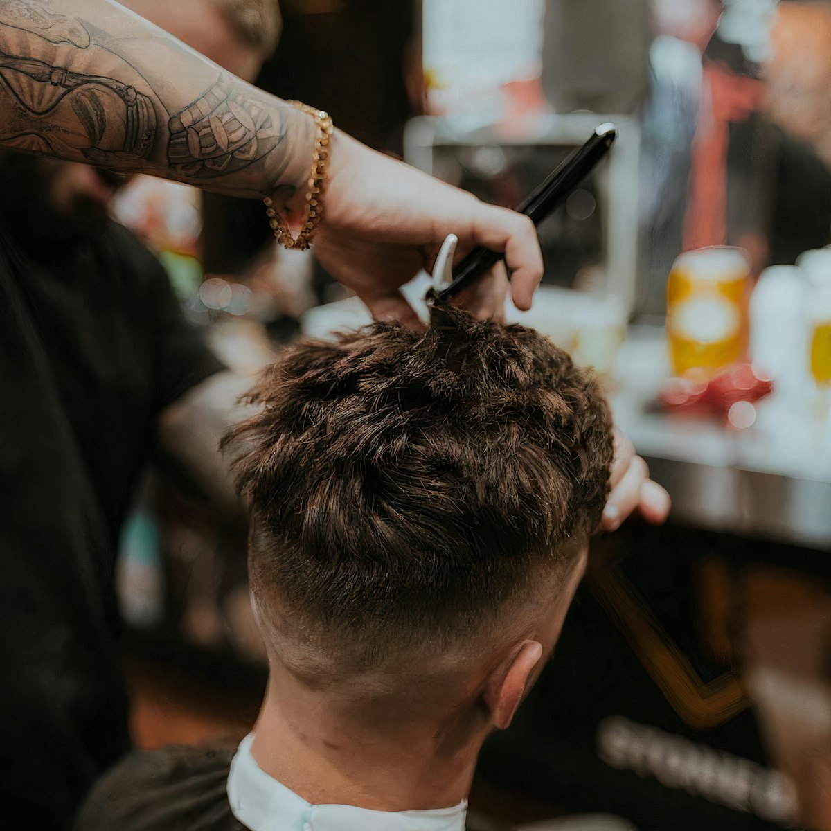 Barber working a fade with a straight razor
